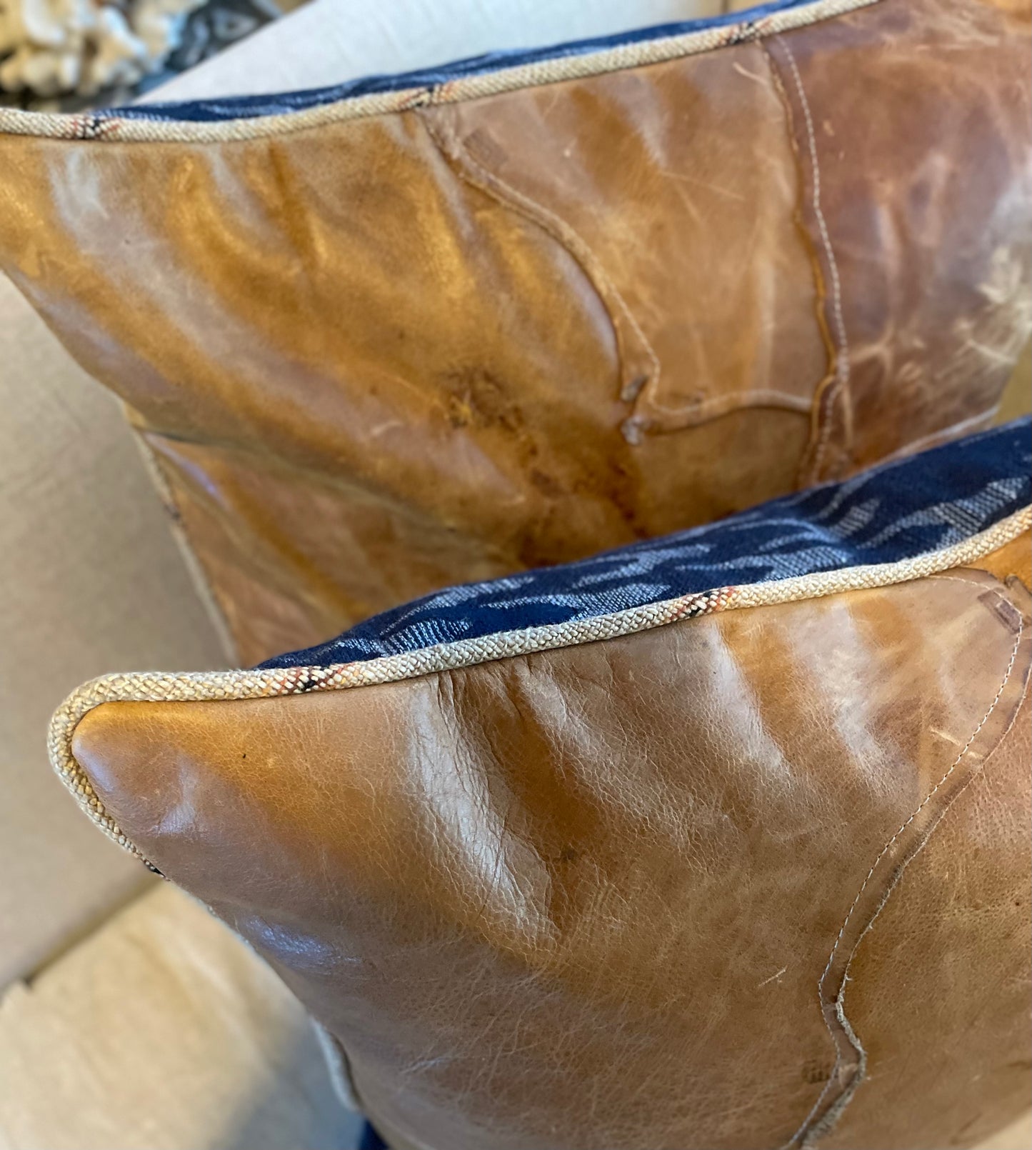 Live edge leather pillows with ranch welt edge and cobalt blue blanket pattern wool